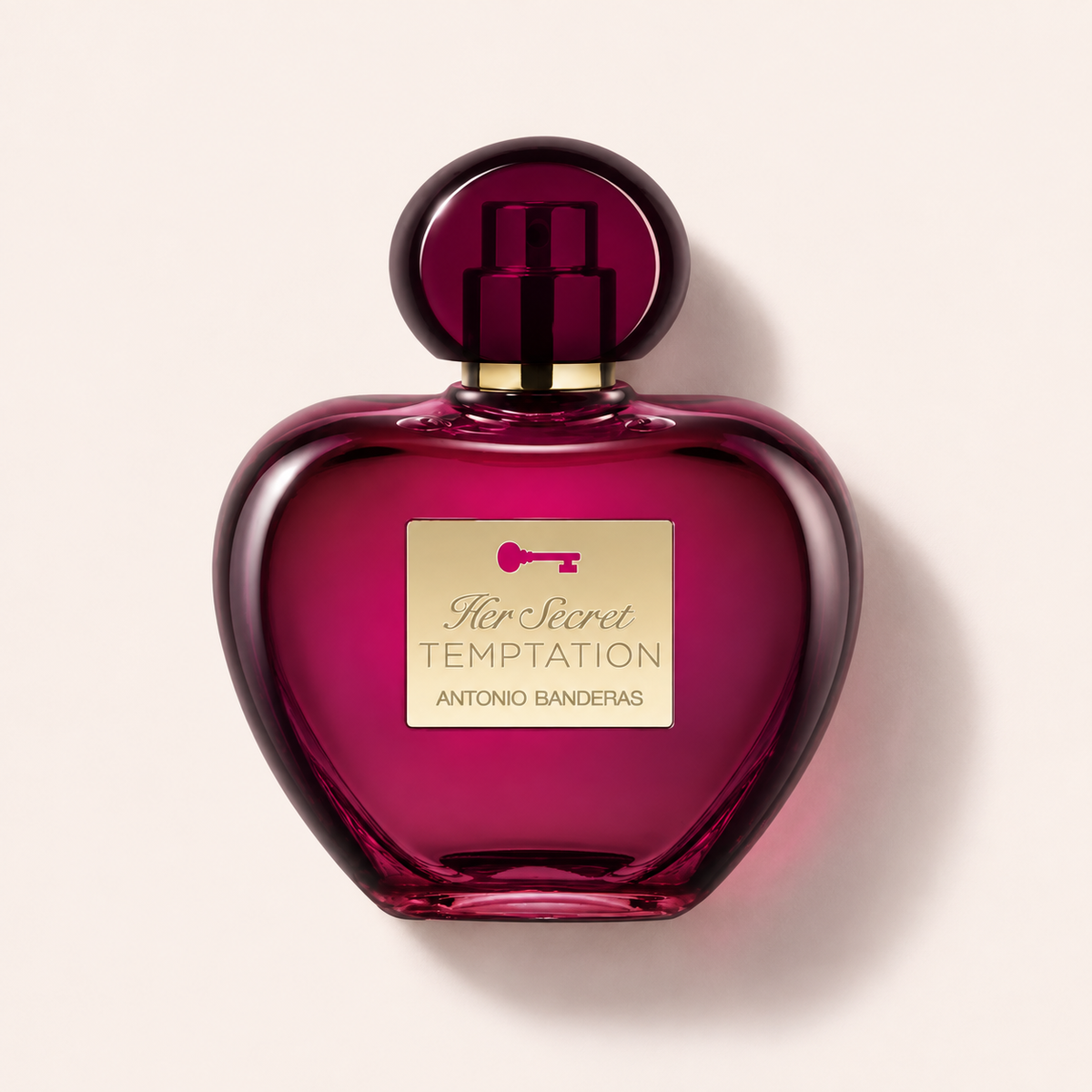 Flakon Banderas Her Secret Temptation EDT 80 ml na pudrově růžovém pozadí – MrRizz